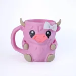 A Pink Cow And Two Spoons