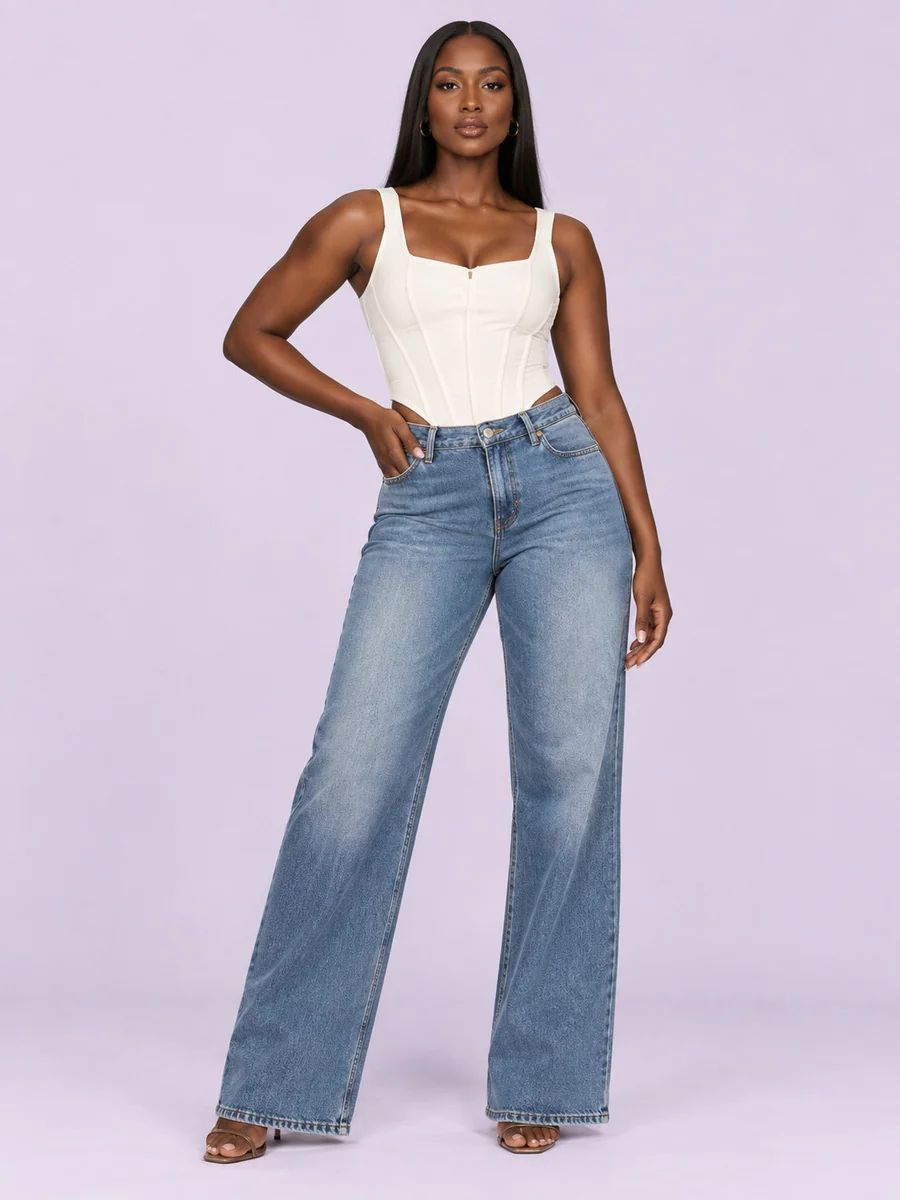 White corset top with wide-leg blue jeans